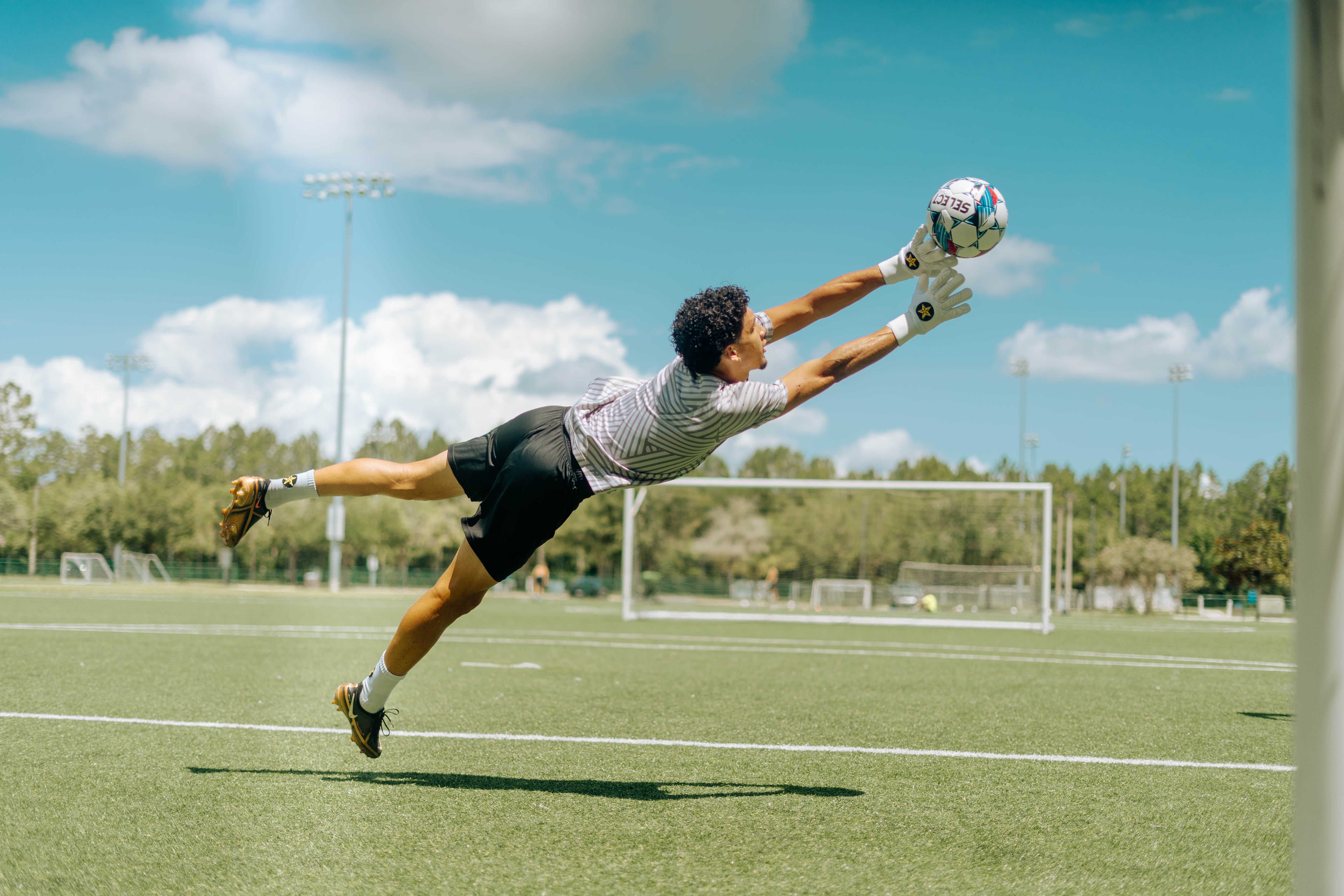 Man tries to catch ball with Goalkeeper gloves